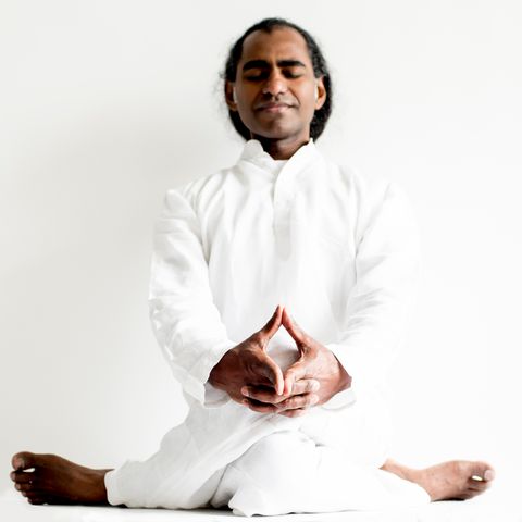Portrait of a yoga teacher seated near a sunlit window